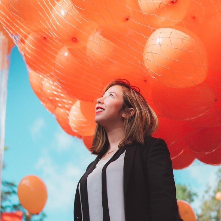 Asha Rao, Lead Design Curator at BeaconTrailLab, reviewing corporate floral arrangements
